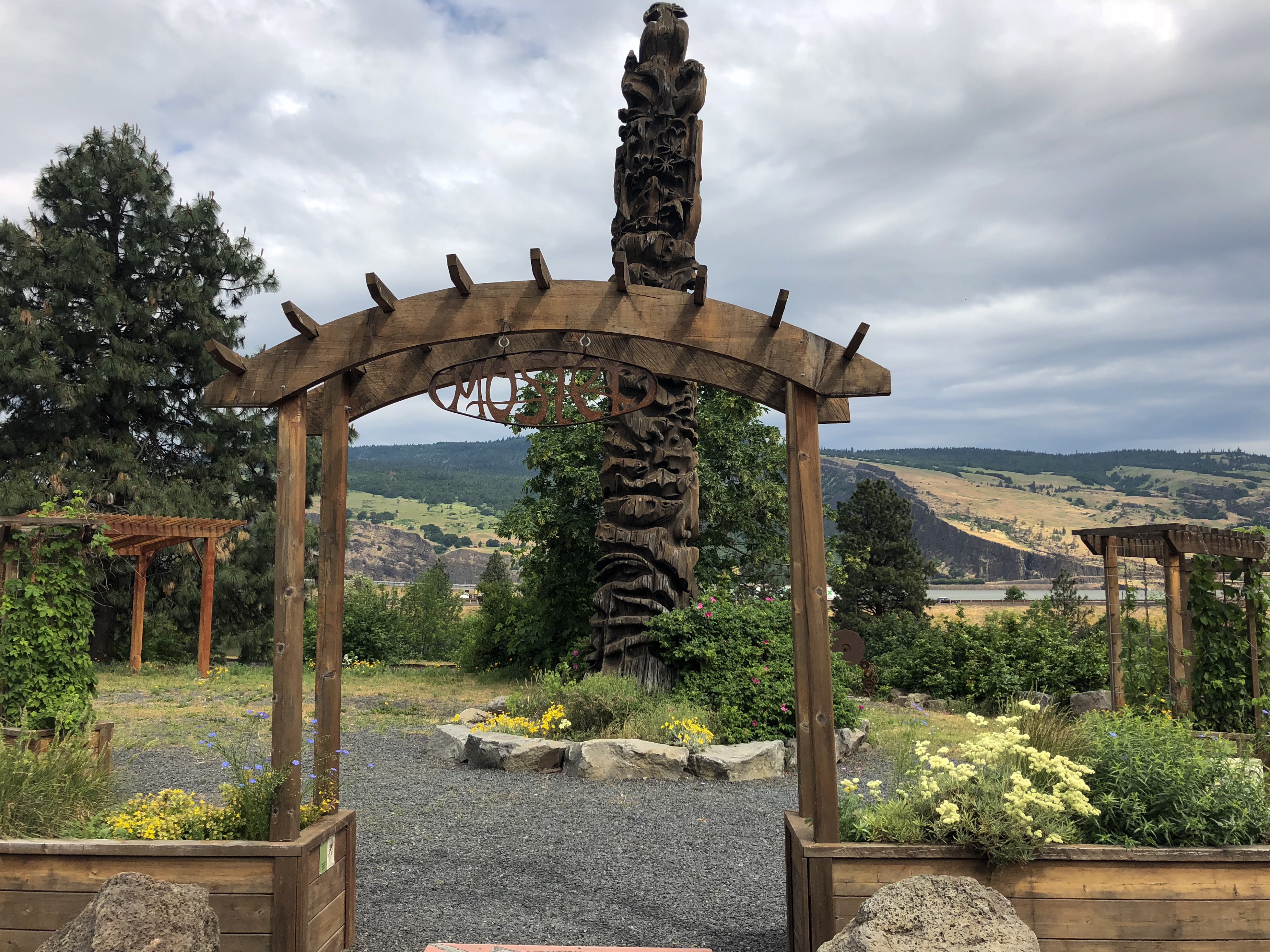 flower garden with wooden arch at entrance