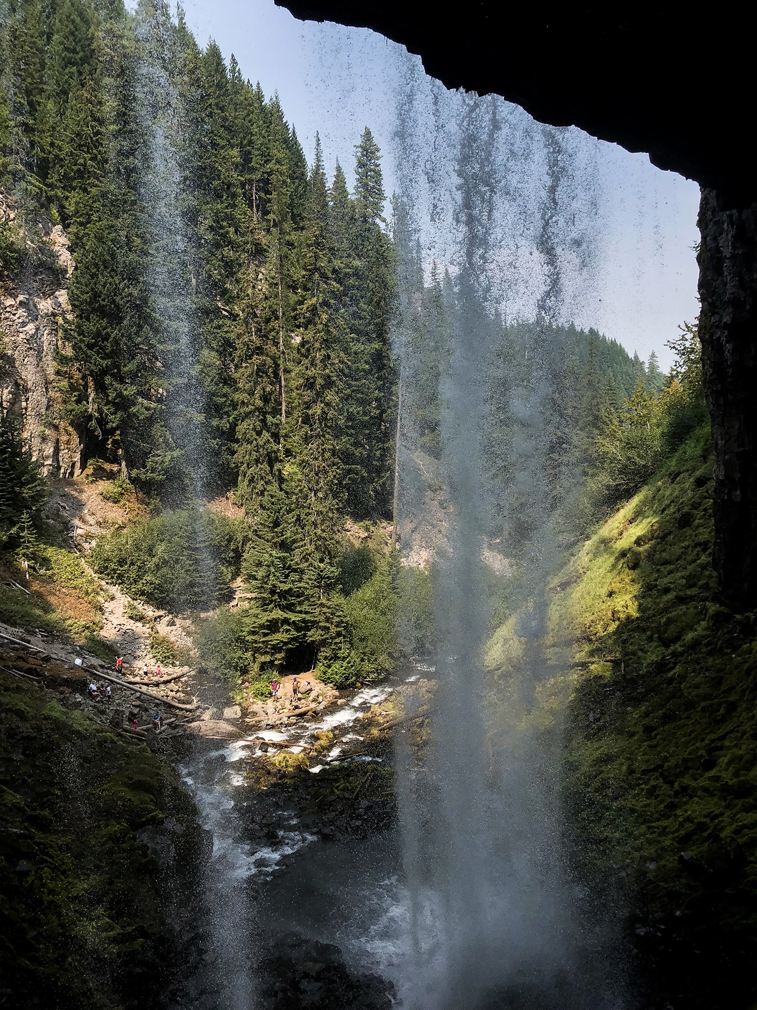 looking out from behind the waterfall